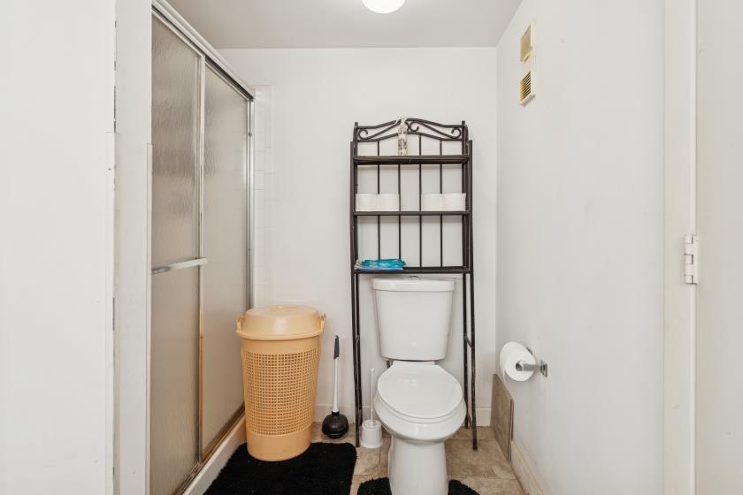 9670 West McNab Road, Unit 208 Tamarac, FL 33321 - Photo 22 of 22 a white toilet sitting next to a bathroom sink