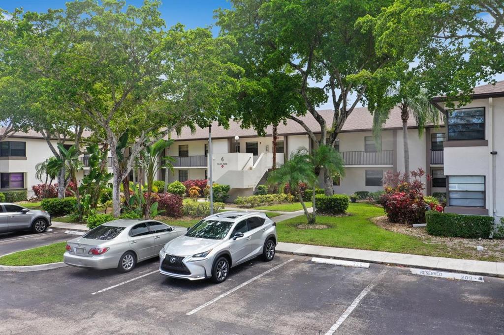 9670 West McNab Road, Unit 208 Tamarac, FL 33321 - Photo 3 of 22 a front view of a house with garden