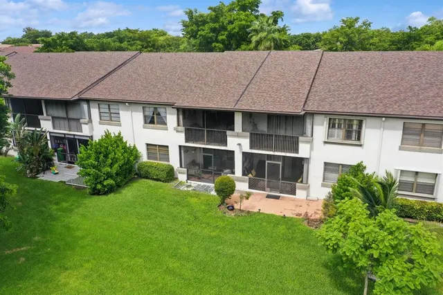 a view of a house with pool and garden
