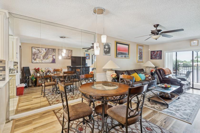 9670 West McNab Road, Unit 208 Tamarac, FL 33321 - Photo 10 of 22 a living room with lots of furniture and outdoor view