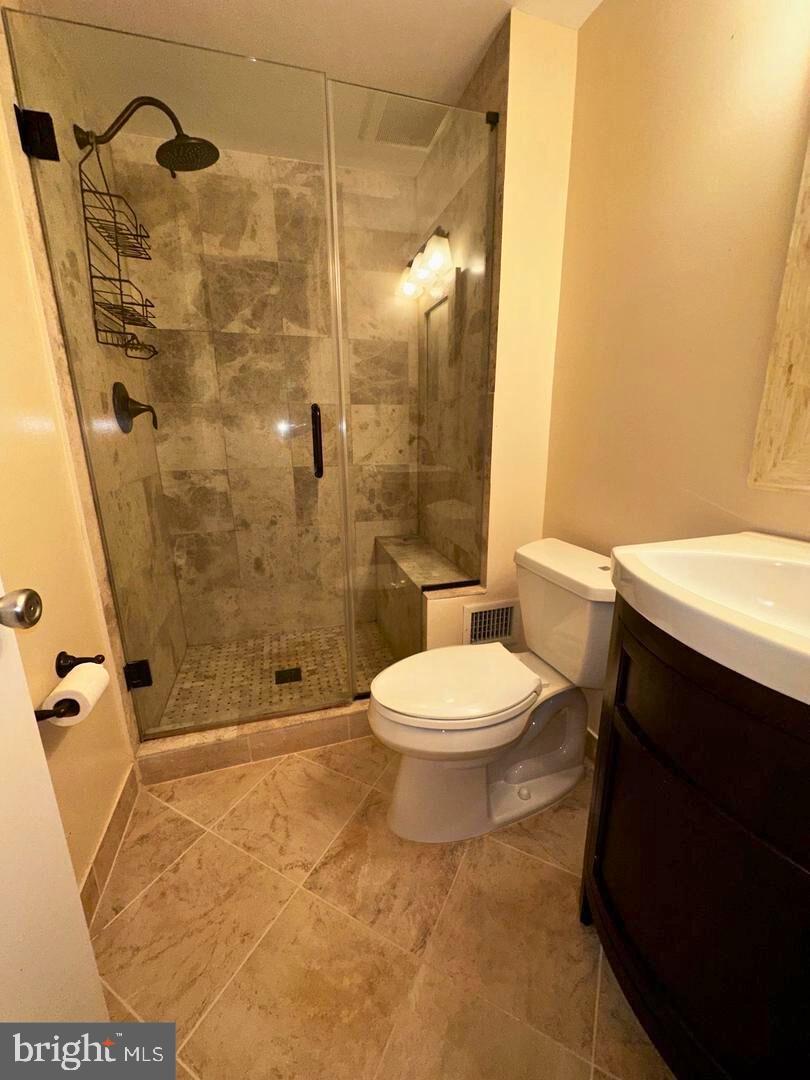 5718 Wood Mouse Court Burke, VA 22015 - Photo 11 of 23 a bathroom with a toilet and a shower