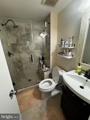 a bathroom with a sink toilet and shower