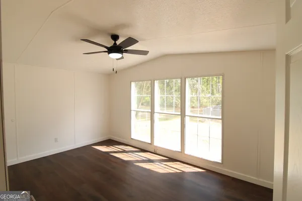 a view of a livingroom with a ceiling fan and window