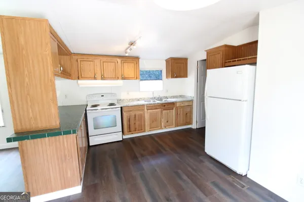 a view of a room with wooden floor and ceiling fan