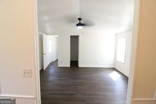a view of a hallway with wooden floor