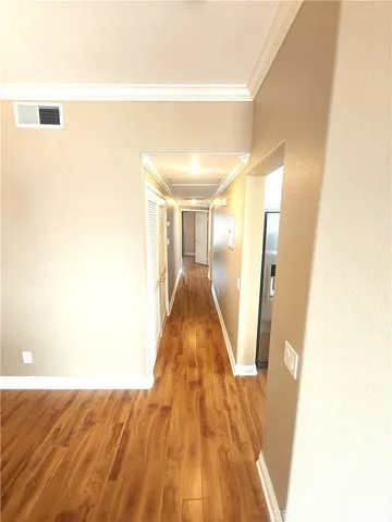 a view of a room with wooden floor