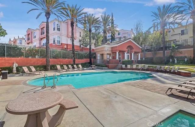 a view of a house with a yard and sitting area