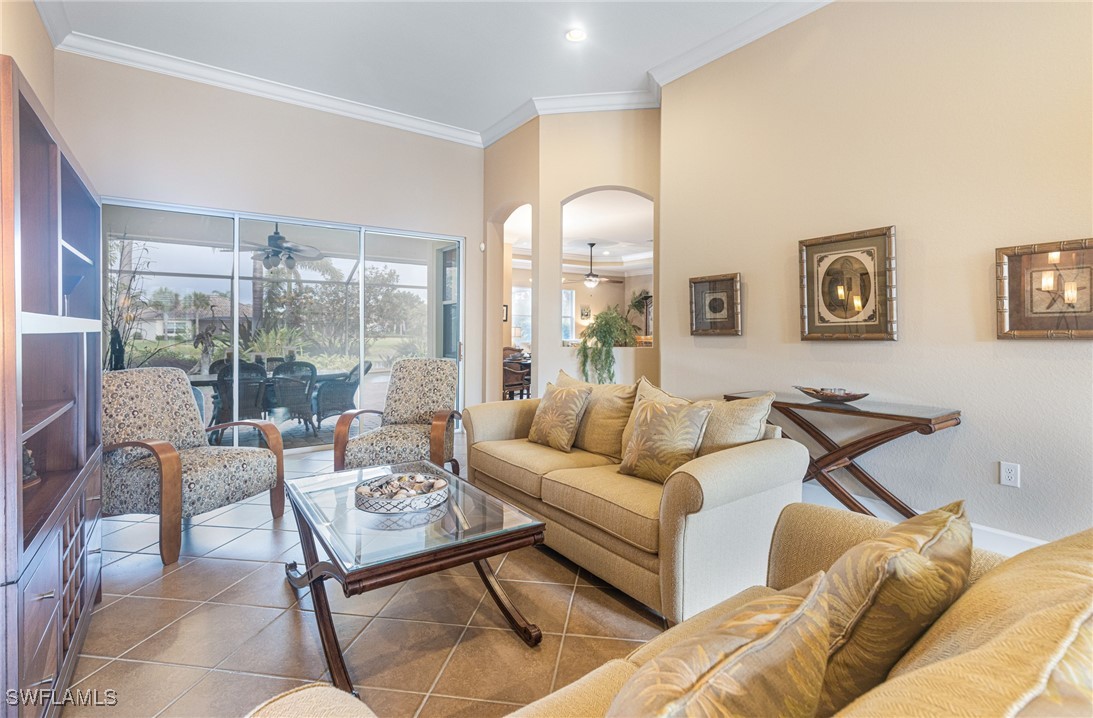 11208 Lithgow Lane Fort Myers, FL 33913 - Photo 11 of 49 a living room with furniture and a large window with garden view