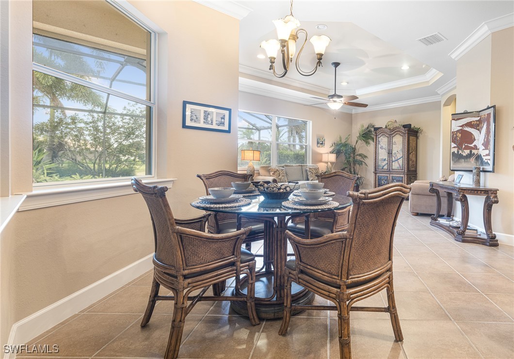 11208 Lithgow Lane Fort Myers, FL 33913 - Photo 12 of 49 a view of a dining room with furniture a chandelier and large windows