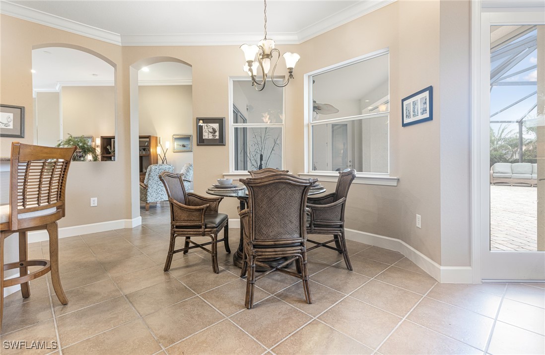 11208 Lithgow Lane Fort Myers, FL 33913 - Photo 13 of 49 a view of a dining room with furniture and a chandelier