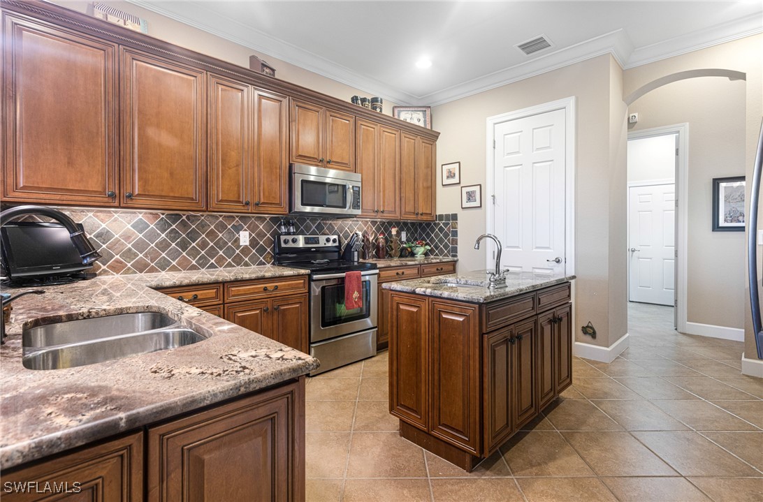 11208 Lithgow Lane Fort Myers, FL 33913 - Photo 14 of 49 a kitchen with granite countertop a sink a counter top space appliances and cabinets