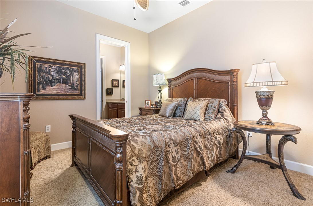 11208 Lithgow Lane Fort Myers, FL 33913 - Photo 22 of 49 a bedroom with a bed and a lamp on table