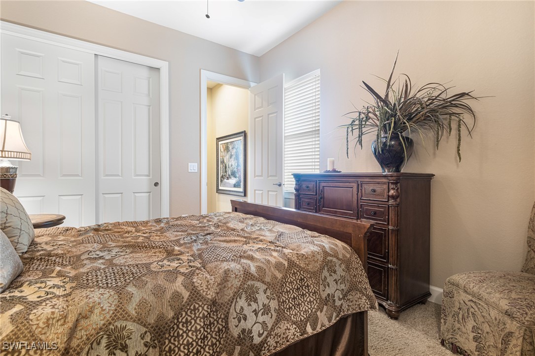 11208 Lithgow Lane Fort Myers, FL 33913 - Photo 24 of 49 a bedroom with a bed and wooden floor