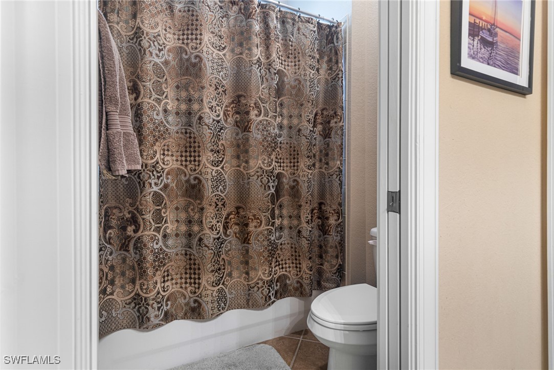 11208 Lithgow Lane Fort Myers, FL 33913 - Photo 27 of 49 a white toilet sitting next to a shower curtain
