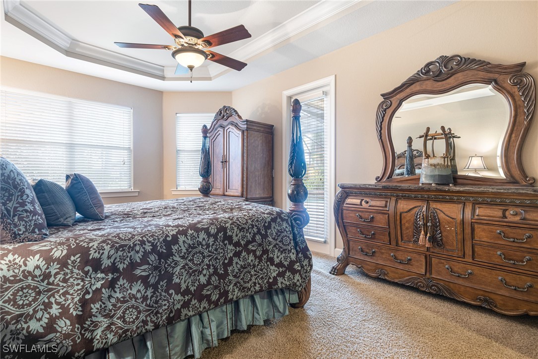 11208 Lithgow Lane Fort Myers, FL 33913 - Photo 32 of 49 a bedroom with a bed dresser and a mirror