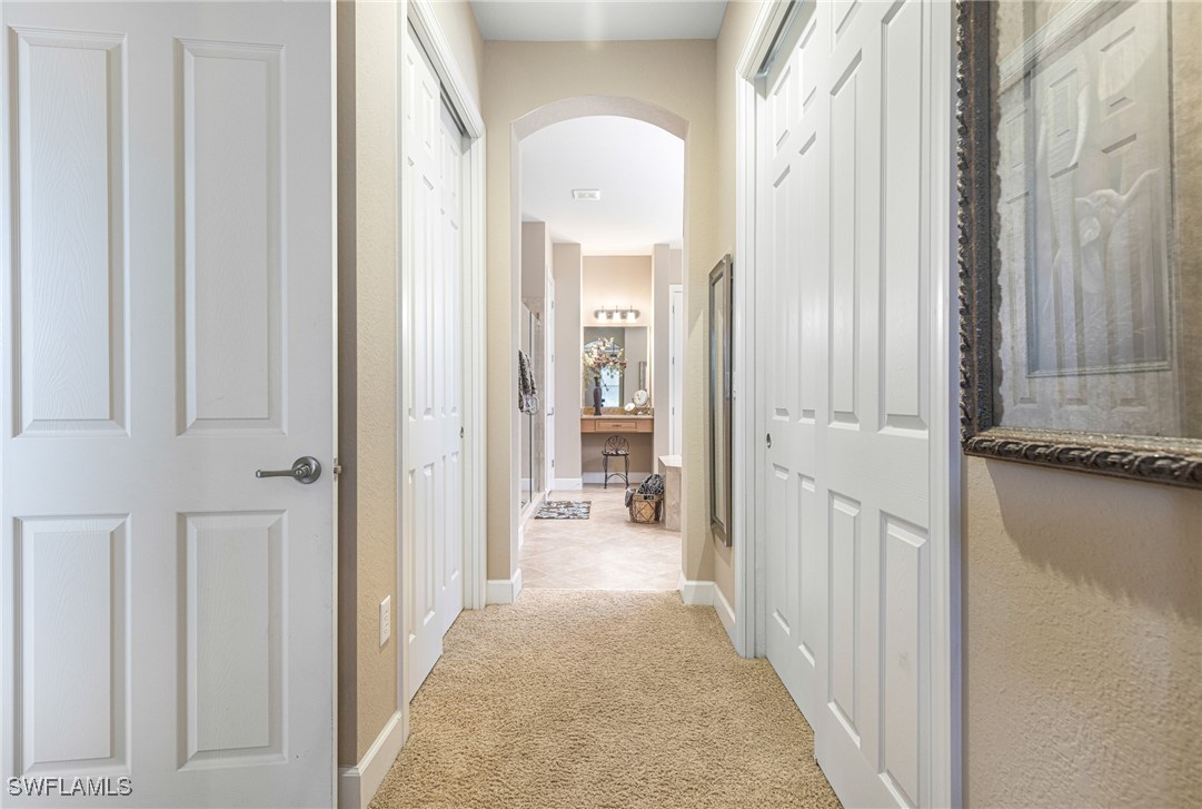 11208 Lithgow Lane Fort Myers, FL 33913 - Photo 34 of 49 a view of a hallway with wooden floor and a bathroom