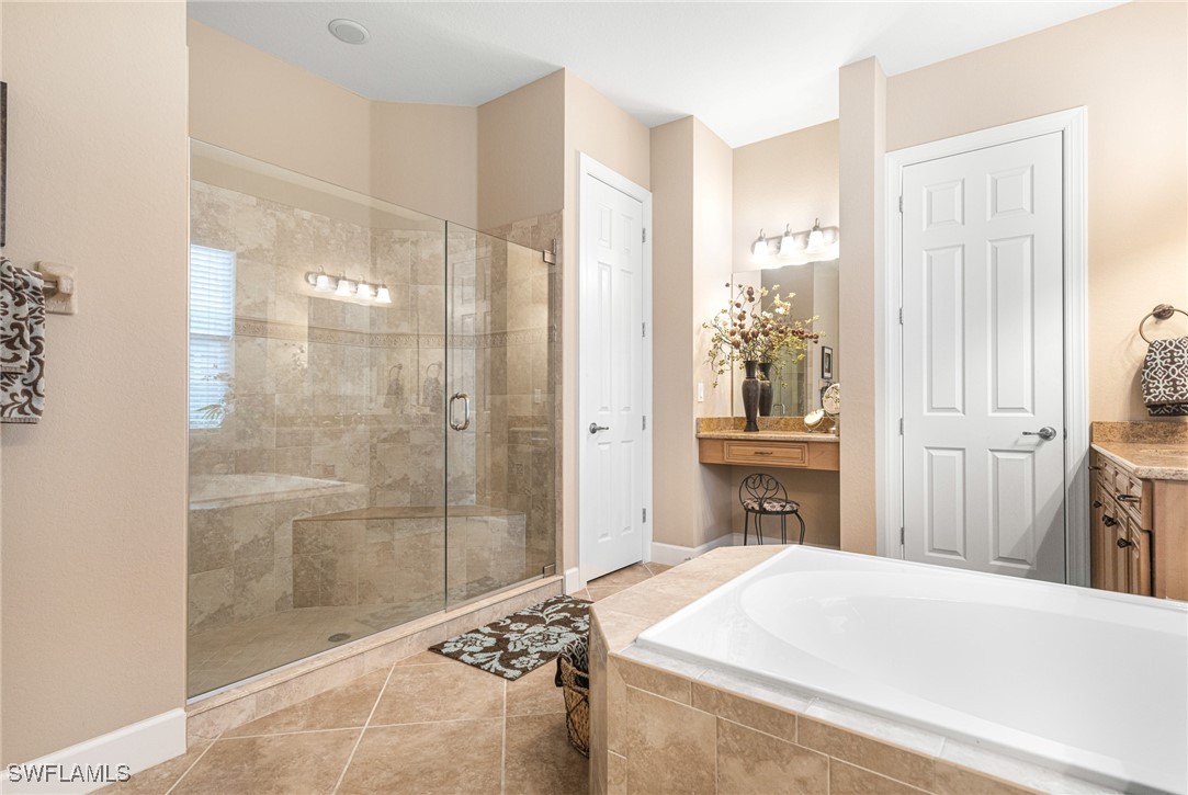 11208 Lithgow Lane Fort Myers, FL 33913 - Photo 36 of 49 a spacious bathroom with a granite countertop sink a shower and a mirror