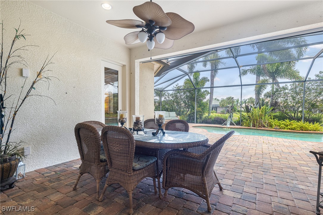11208 Lithgow Lane Fort Myers, FL 33913 - Photo 39 of 49 a dining room with furniture a chandelier and a rug