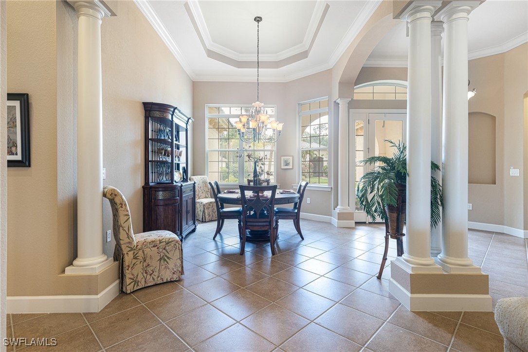 11208 Lithgow Lane Fort Myers, FL 33913 - Photo 48 of 49 a dining room with furniture a chandelier and wooden floor