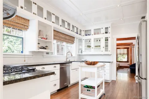 a kitchen with stainless steel appliances granite countertop a stove and a sink