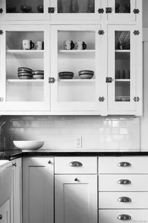 a close view of a stove top oven and cabinets
