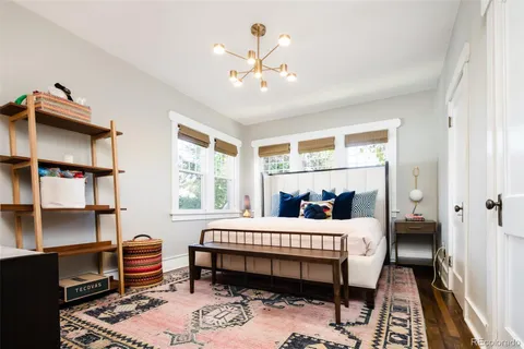 a bedroom with a bed and a chandelier