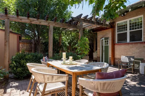 a view of outdoor sitting area with furniture and wooden floor