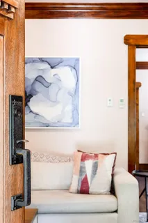 a living room with furniture and a painting