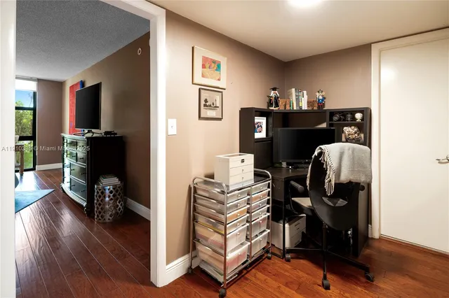 a view of a workspace with furniture and wooden floor