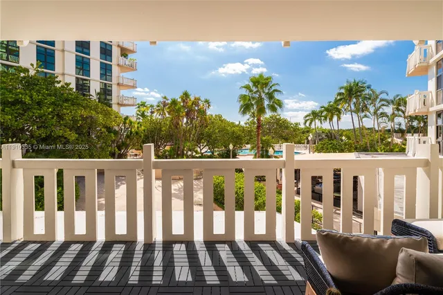 a view of a chair and tables in the balcony