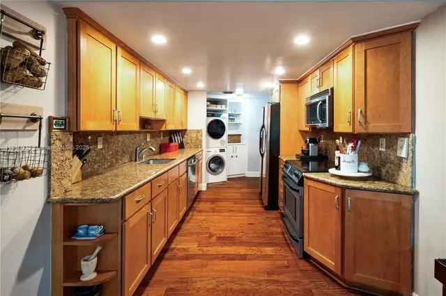 a kitchen with stainless steel appliances a sink stove and cabinets