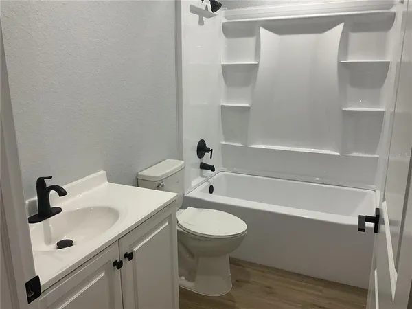 a bathroom with a shower and toilet
