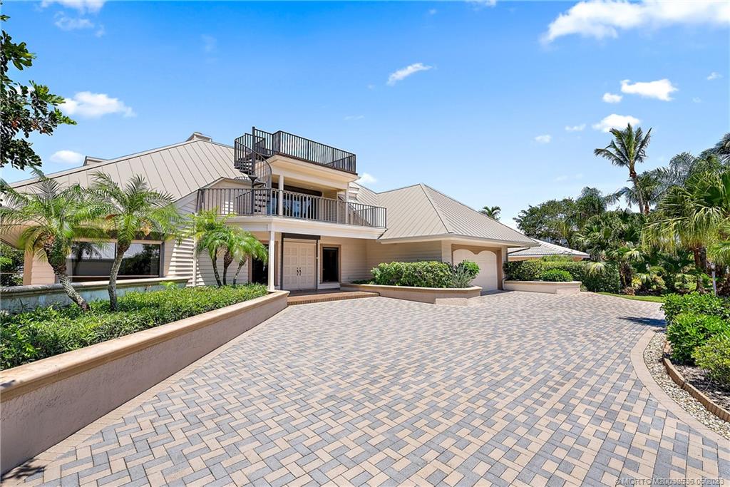 19 Island Road Sewall's Point, FL 34996 - Photo 14 of 50 a front view of a house with a yard and a garage