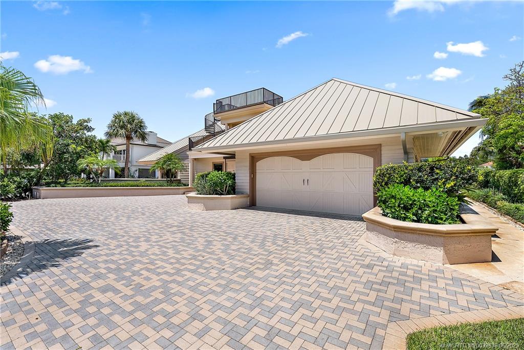 19 Island Road Sewall's Point, FL 34996 - Photo 16 of 50 a front view of a house with a yard and potted plants
