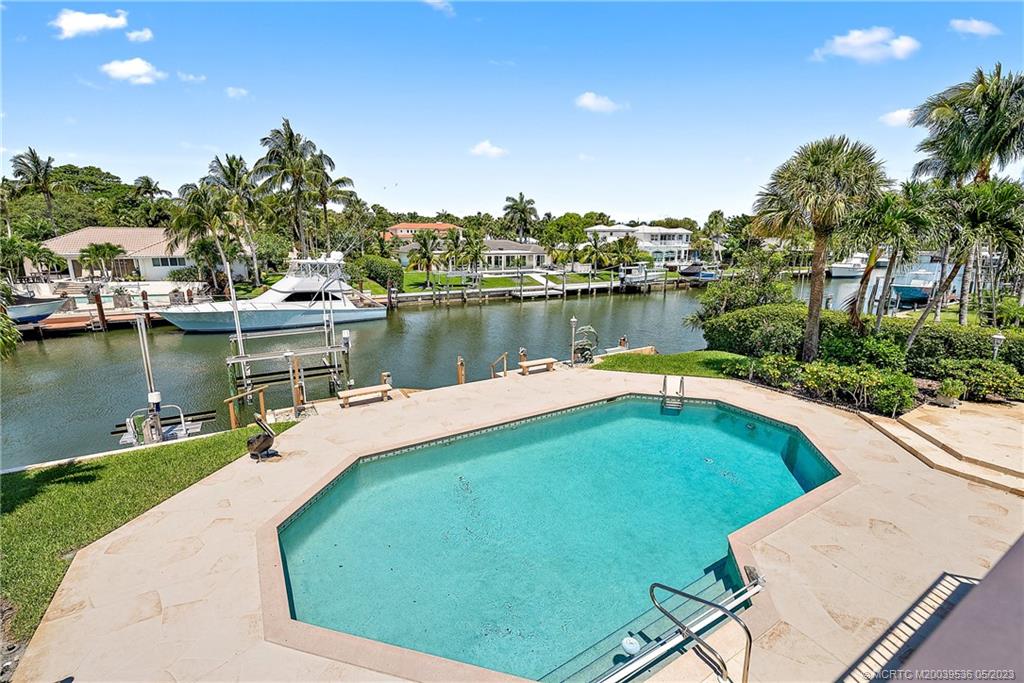 19 Island Road Sewall's Point, FL 34996 - Photo 20 of 50 a view of a lake with a house in the background