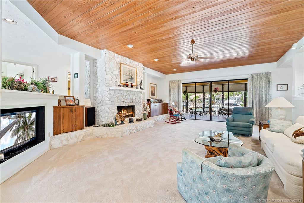 19 Island Road Sewall's Point, FL 34996 - Photo 22 of 50 a living room with furniture a fireplace and a table