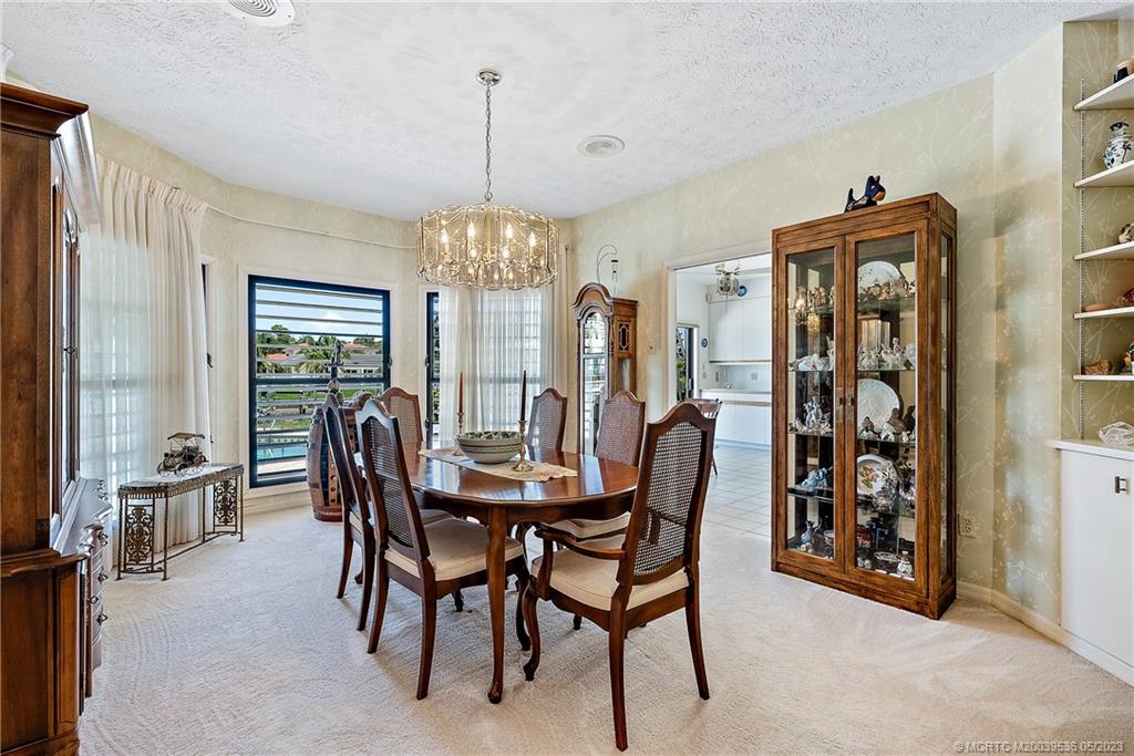 19 Island Road Sewall's Point, FL 34996 - Photo 24 of 50 a view of a dining room with furniture and chandelier