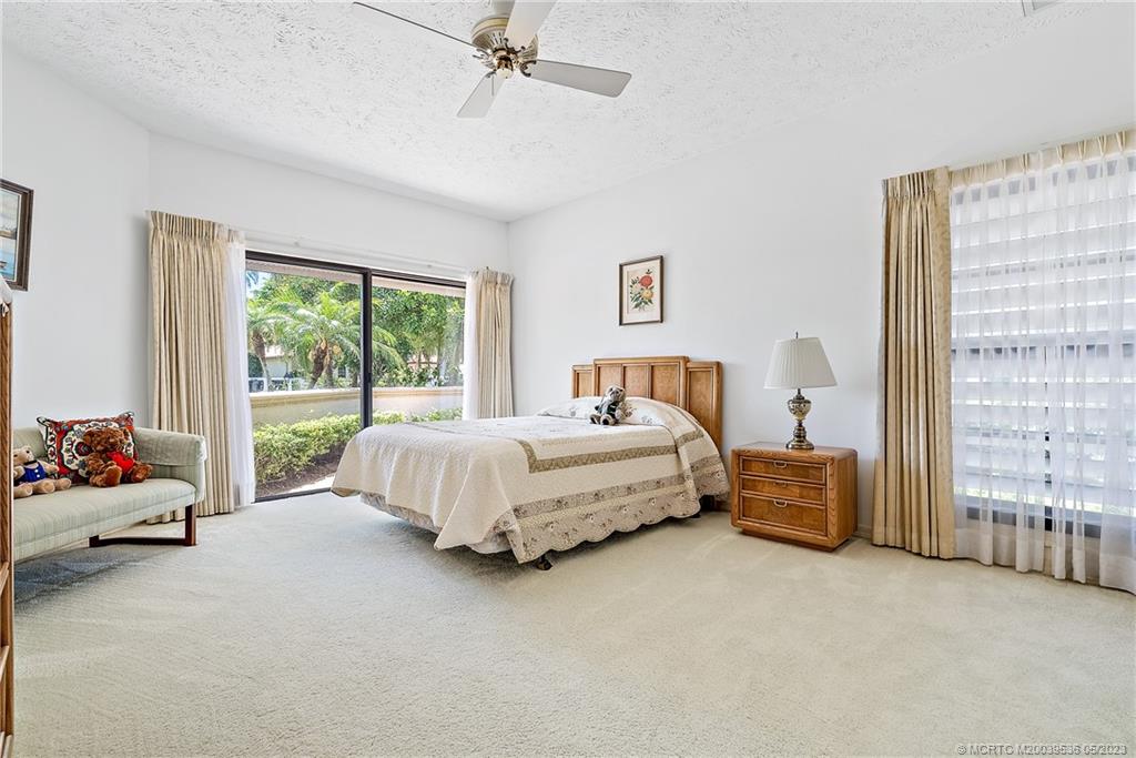 19 Island Road Sewall's Point, FL 34996 - Photo 30 of 50 a bedroom with a bed and glass window