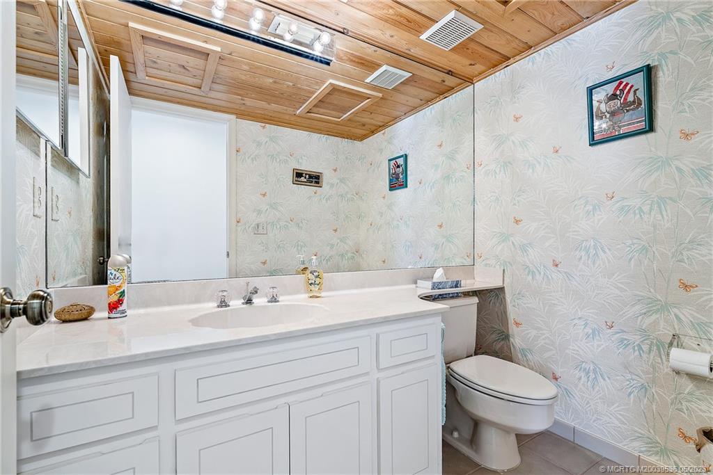 19 Island Road Sewall's Point, FL 34996 - Photo 32 of 50 a bathroom with a sink mirror vanity and toilet