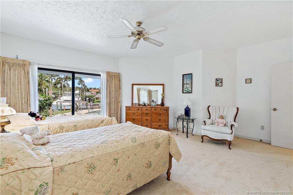 19 Island Road Sewall's Point, FL 34996 - Photo 34 of 50 a bedroom with a bed and wooden floor