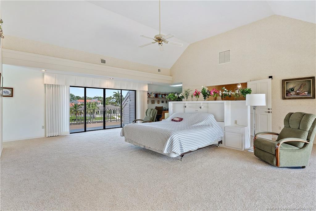 19 Island Road Sewall's Point, FL 34996 - Photo 36 of 50 a spacious bedroom with a bed and large window