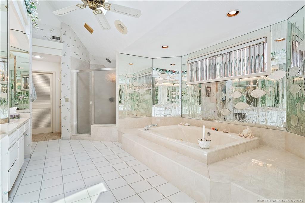 19 Island Road Sewall's Point, FL 34996 - Photo 39 of 50 a spacious bathroom with a tub and a shower