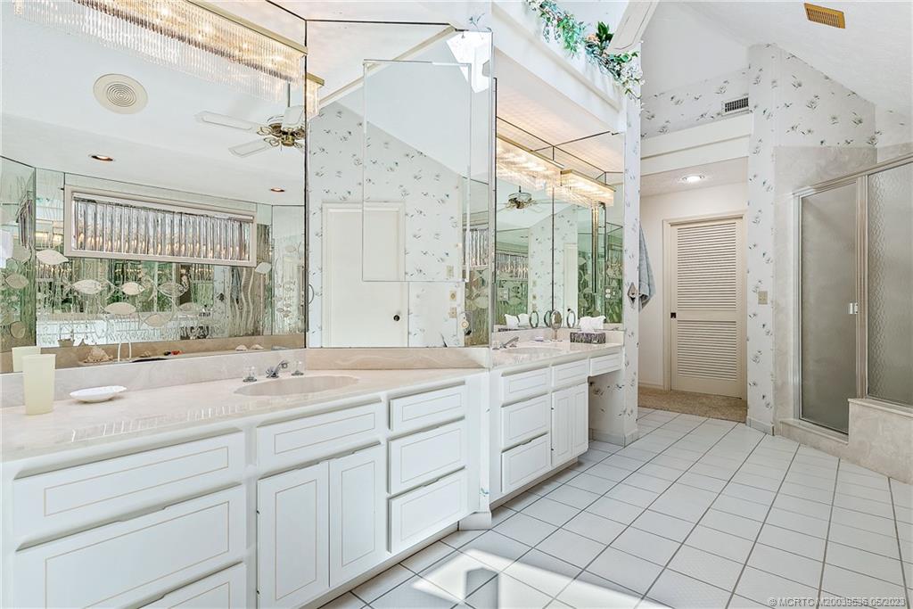 19 Island Road Sewall's Point, FL 34996 - Photo 40 of 50 a spacious bathroom with a double vanity sink mirror and shower