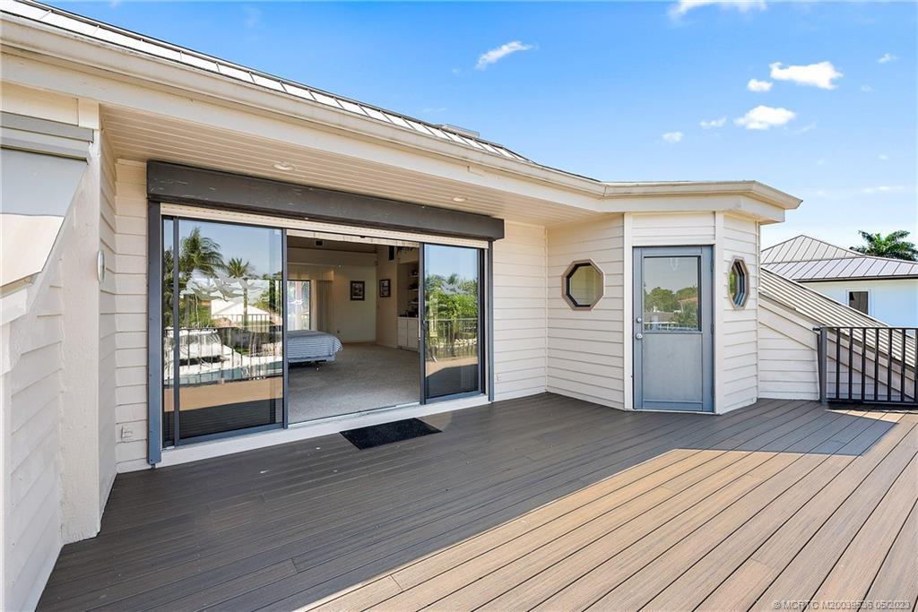 19 Island Road Sewall's Point, FL 34996 - Photo 42 of 50 a view of a porch with wooden floor and stairs