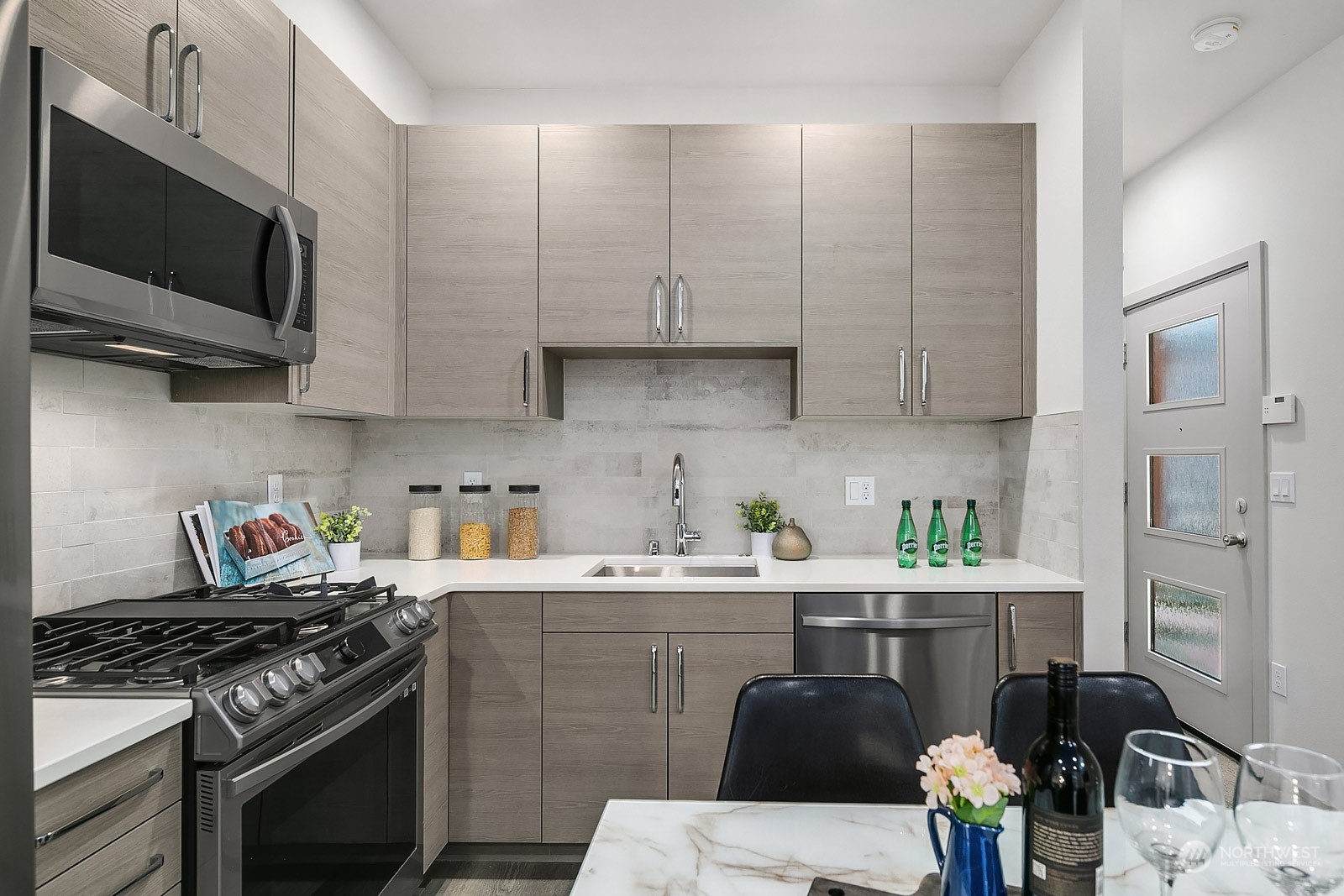 1123 D 18th Avenue Seattle, WA 98122 - Photo 11 of 22 a kitchen with stainless steel appliances a sink a stove top oven a counter space and cabinets