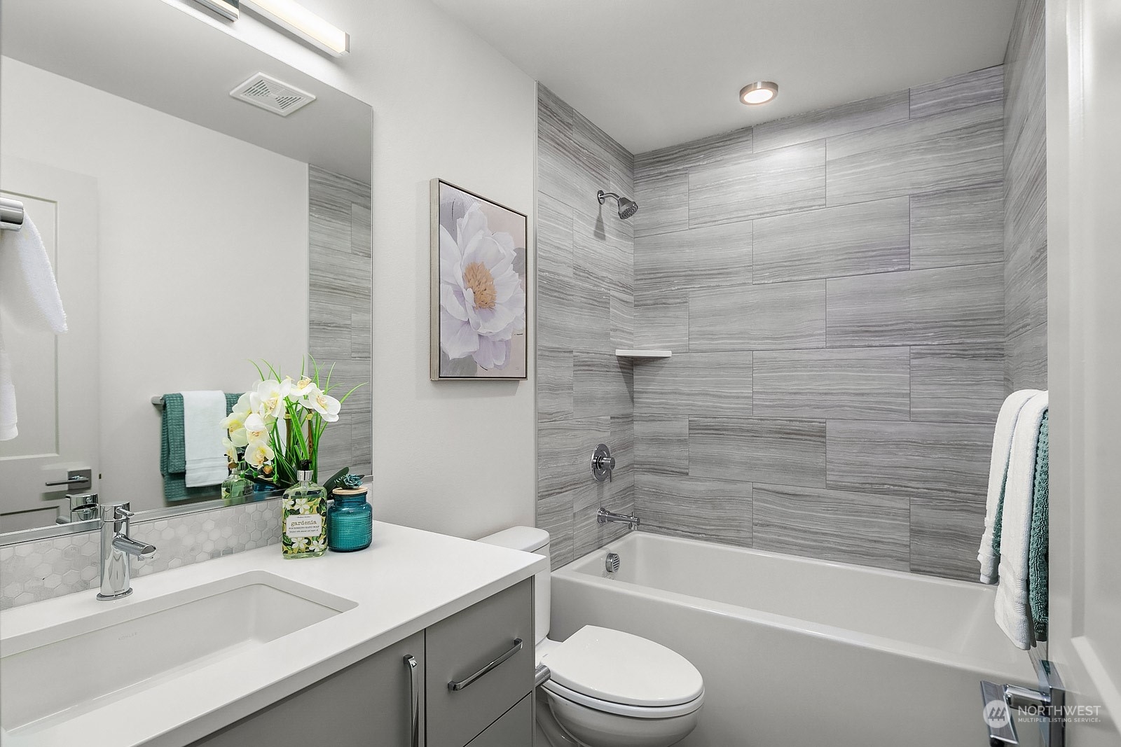1123 D 18th Avenue Seattle, WA 98122 - Photo 18 of 22 a bathroom with a granite countertop bathtub shower sink vanity mirror and toilet