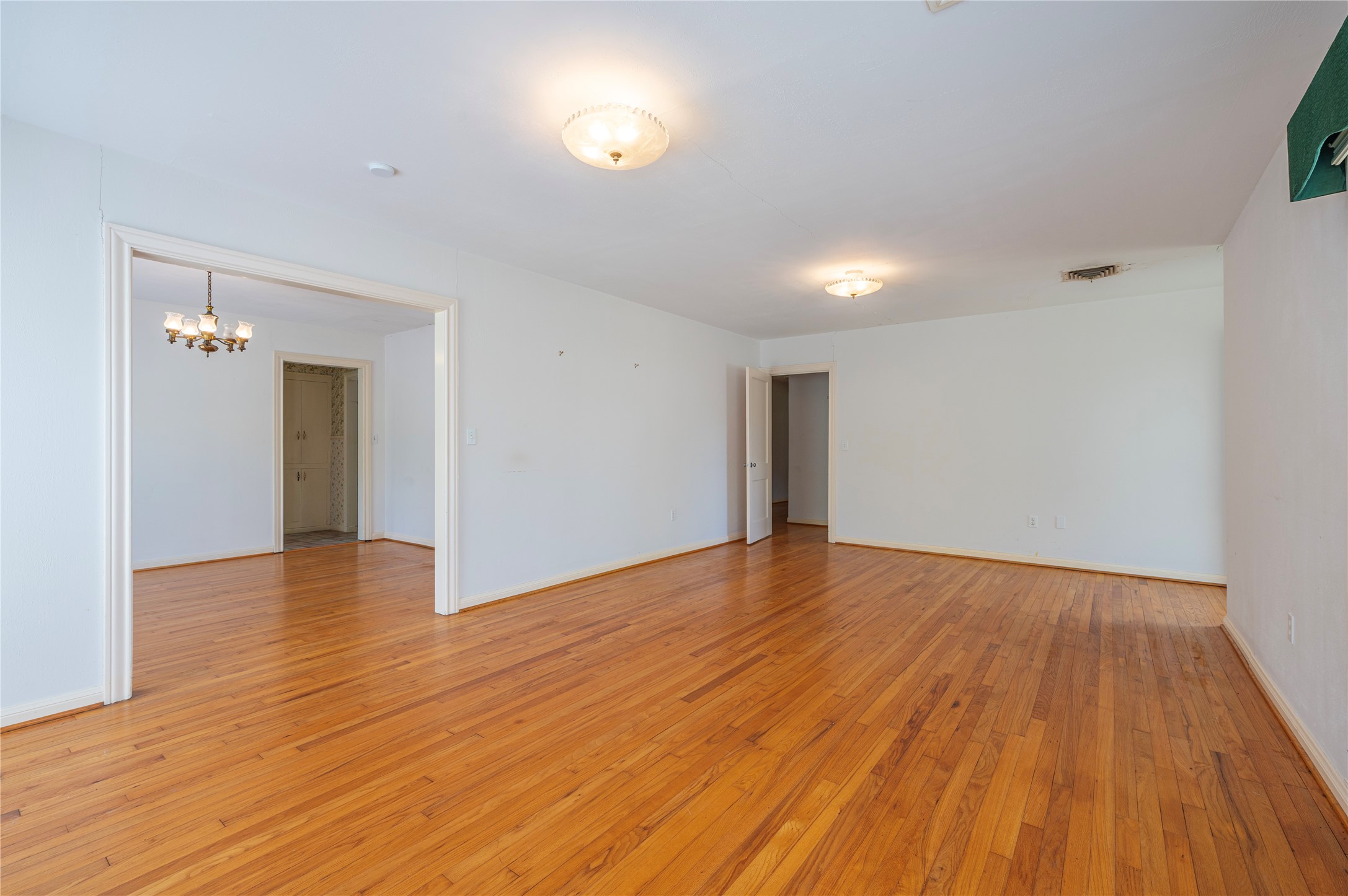 418 East Strand Street El Campo, TX 77437 - Photo 11 of 20 a view of empty room with wooden floor and fan