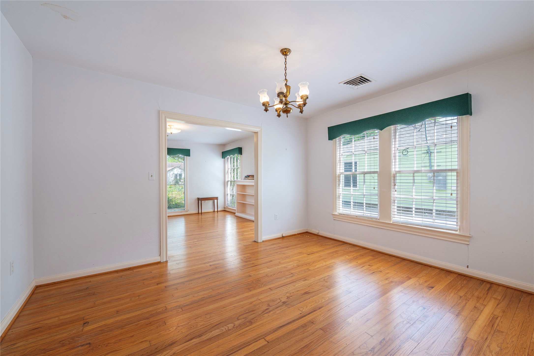 418 East Strand Street El Campo, TX 77437 - Photo 13 of 20 an empty room with wooden floor and windows
