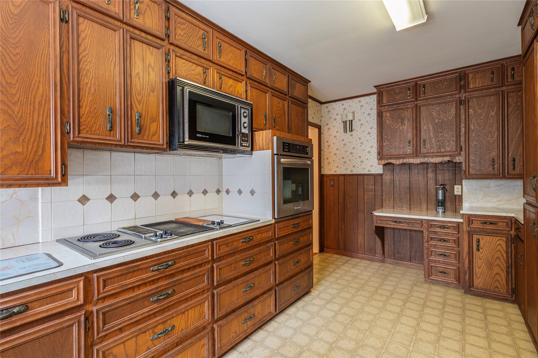 418 East Strand Street El Campo, TX 77437 - Photo 16 of 20 a kitchen with stainless steel appliances granite countertop a stove top oven a sink dishwasher and a refrigerator with wooden cabinets