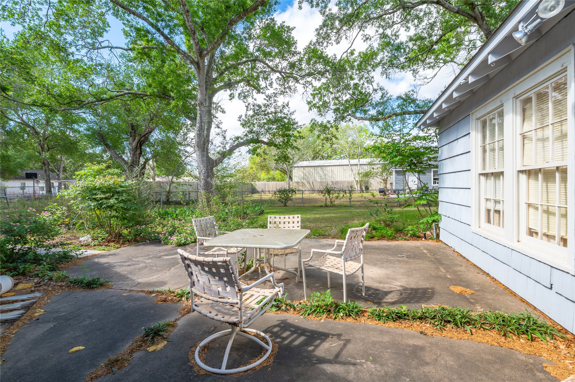 418 East Strand Street El Campo, TX 77437 - Photo 20 of 20 a view of a patio with table and chairs next to a yard